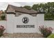 Brookstone neighborhood entrance featuring a brick sign and landscaping at 5499 Steven Dr, Greenwood, IN 46142