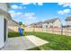 Fenced backyard with well-maintained lawn, patio, and playset for entertainment and outdoor activities at 5518 Wood Spring Ln, McCordsville, IN 46055