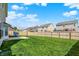 Grassy backyard featuring a playset, patio, and full-perimeter fencing for privacy at 5518 Wood Spring Ln, McCordsville, IN 46055