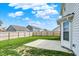 Well-maintained backyard featuring a patio, lush lawn, and secure wood fence for privacy at 5518 Wood Spring Ln, McCordsville, IN 46055