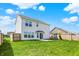 Spacious backyard showing well-maintained lawn, patio, playground and privacy fence, ideal for Gathering activities at 5518 Wood Spring Ln, McCordsville, IN 46055