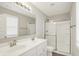 Bright bathroom features a double sink vanity, glass shower doors, and a large mirror at 5518 Wood Spring Ln, McCordsville, IN 46055