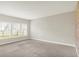 Spacious bedroom with soft carpet, a large window, and a neutral color scheme, providing a blank canvas at 5518 Wood Spring Ln, McCordsville, IN 46055