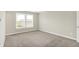 Bright bedroom features neutral gray walls, plush carpeting, and a window offering neighborhood views at 5518 Wood Spring Ln, McCordsville, IN 46055