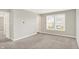 Neutral bedroom with gray carpet, light walls, and a window view, creating a blank canvas for personalization at 5518 Wood Spring Ln, McCordsville, IN 46055