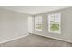 Bright bedroom with plush carpet, two windows offering neighborhood views, and white trim at 5518 Wood Spring Ln, McCordsville, IN 46055