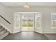Bright dining area features hardwood floors, many windows, and sliding glass door leading to the backyard at 5518 Wood Spring Ln, McCordsville, IN 46055