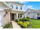 Inviting front porch with brick accents and manicured landscaping, enhancing the curb appeal of the home at 5518 Wood Spring Ln, McCordsville, IN 46055