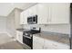Kitchen area with stainless steel appliances and granite countertops at 5518 Wood Spring Ln, McCordsville, IN 46055