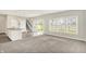 Bright living room with large windows, carpet, and sliding door leading to the backyard at 5518 Wood Spring Ln, McCordsville, IN 46055