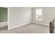 Upstairs loft space is carpeted and features a window with natural light at 5518 Wood Spring Ln, McCordsville, IN 46055