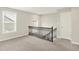 Upstairs loft space is carpeted and features two windows and a closet at 5518 Wood Spring Ln, McCordsville, IN 46055