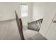 Carpeted staircase features stained railing and trim and leads to the upper level of the home at 5518 Wood Spring Ln, McCordsville, IN 46055