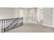 The upstairs hallway is carpeted and features a stairway railing with decorative wallpaper on the adjacent wall at 5518 Wood Spring Ln, McCordsville, IN 46055