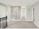 The upstairs hallway is carpeted and features a stairway railing with decorative wallpaper on the adjacent wall at 5518 Wood Spring Ln, McCordsville, IN 46055