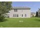 Expansive backyard featuring a lush lawn and a charming fire pit, ideal for outdoor gatherings at 5646 Skipping Stone Dr, Indianapolis, IN 46237