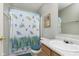 Bathroom featuring a shower with a decorative curtain, a white sink, and neutral walls at 5646 Skipping Stone Dr, Indianapolis, IN 46237