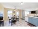 Eat-in kitchen features a tile floor, outside access, and a view of the living room at 5646 Skipping Stone Dr, Indianapolis, IN 46237