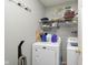 Laundry room equipped with a washer, dryer, shelves, and hanging rack at 5646 Skipping Stone Dr, Indianapolis, IN 46237