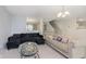 Spacious living room featuring plush sofas, neutral walls, and a carpeted floor at 5646 Skipping Stone Dr, Indianapolis, IN 46237
