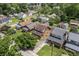 Aerial view of a brick two-story home nestled in a mature residential neighborhood at 6051 Lowell Ave, Indianapolis, IN 46219
