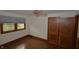 Bedroom with hardwood floors, natural light and wood closet doors at 6051 Lowell Ave, Indianapolis, IN 46219