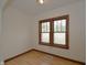 Bedroom with hardwood floors, a large window, and neutral paint at 6051 Lowell Ave, Indianapolis, IN 46219