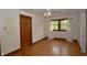 Bedroom with hardwood floors, a large window, and neutral paint at 6051 Lowell Ave, Indianapolis, IN 46219