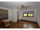 Bedroom with hardwood floors, ceiling fan, and windows providing natural light at 6051 Lowell Ave, Indianapolis, IN 46219