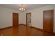 Empty dining room showcasing hardwood floors and natural wood trim at 6051 Lowell Ave, Indianapolis, IN 46219