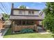 Charming two-story brick home with a welcoming front porch and landscaped front yard at 6051 Lowell Ave, Indianapolis, IN 46219