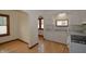 Bright kitchen features white cabinets, stainless sink, gas range and wood flooring at 6051 Lowell Ave, Indianapolis, IN 46219