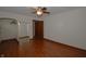 Living room with hardwood floors, ceiling fan, and closet at 6051 Lowell Ave, Indianapolis, IN 46219