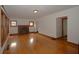 Bright living room featuring hardwood floors, a brick fireplace, and multiple windows at 6051 Lowell Ave, Indianapolis, IN 46219