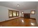 Cozy living room with hardwood floors, a brick fireplace, and natural light from the windows at 6051 Lowell Ave, Indianapolis, IN 46219