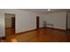 Open living room with hardwood floors and access to additional rooms at 6051 Lowell Ave, Indianapolis, IN 46219