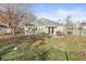 Brick home with a wooden deck in a big backyard with a grill and nice trees at 617 Grovewood Dr, Beech Grove, IN 46107