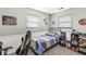 This bedroom features two large windows with a basketball theme and modern furnishings at 617 Grovewood Dr, Beech Grove, IN 46107
