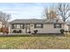 Charming one-story home featuring a brick facade, cozy front porch, and well-maintained landscaping at 617 Grovewood Dr, Beech Grove, IN 46107