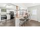 A kitchen featuring modern appliances, wood floors, and an open bar area at 617 Grovewood Dr, Beech Grove, IN 46107