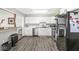 Well-lit kitchen boasts white cabinets, stainless steel appliances, and a functional layout at 617 Grovewood Dr, Beech Grove, IN 46107
