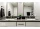 Modern bathroom featuring double sinks, gray countertops, and stylish black and white accents at 622 E 10Th St # 212, Indianapolis, IN 46202