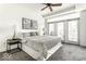 Bright bedroom with large windows, balcony access, and a stylishly decorated queen-sized bed at 622 E 10Th St # 212, Indianapolis, IN 46202