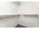 An empty walk-in closet features neutral carpet and wood shelving at 622 E 10Th St # 212, Indianapolis, IN 46202