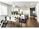 Bright open dining room with modern pendant lights, glass table, and open access to the kitchen at 622 E 10Th St # 212, Indianapolis, IN 46202