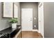 Modern condo entryway featuring hardwood floors, stylish décor, and white trim at 622 E 10Th St # 212, Indianapolis, IN 46202
