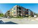 Modern apartment complex featuring brick and siding, multiple balconies, and street parking at 622 E 10Th St # 212, Indianapolis, IN 46202