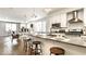 Bright condo kitchen with stainless steel appliances, white cabinets, and an island with barstool seating at 622 E 10Th St # 212, Indianapolis, IN 46202