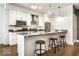 Modern condo kitchen with white cabinets, stainless steel appliances, and island with barstool seating at 622 E 10Th St # 212, Indianapolis, IN 46202