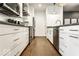 Well-equipped condo kitchen with white cabinets, stainless steel appliances, and hardwood floors at 622 E 10Th St # 212, Indianapolis, IN 46202